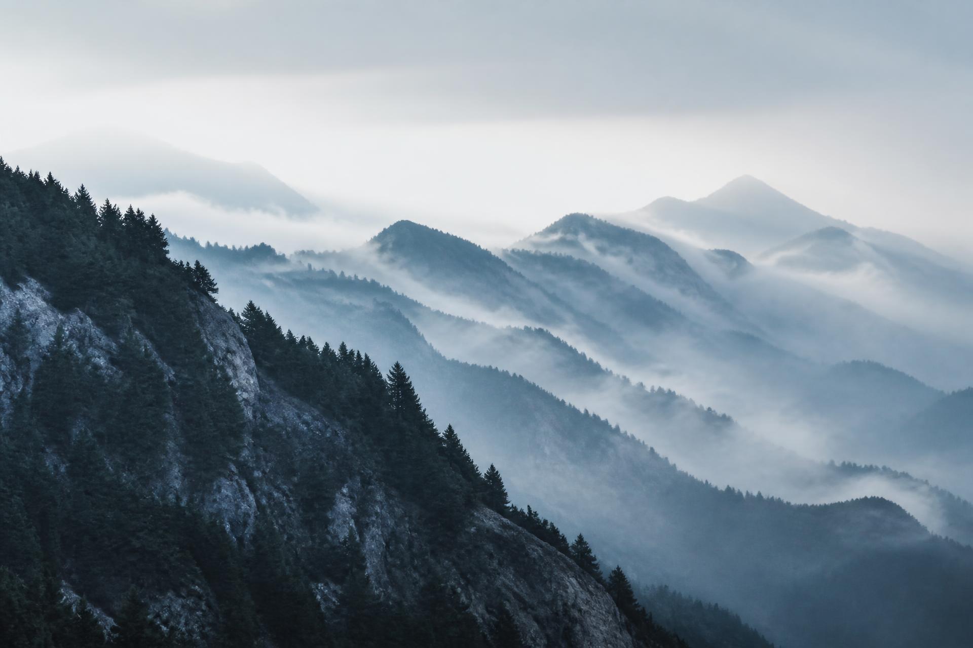 Misty fir-covered mountain ridges of Epirus at dawn